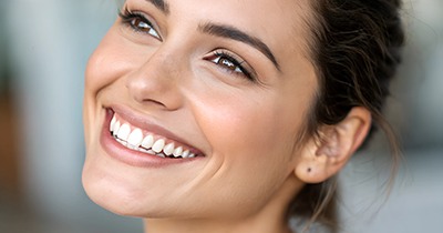 Young female smiling after seeing United Concordia dentist in Grafton