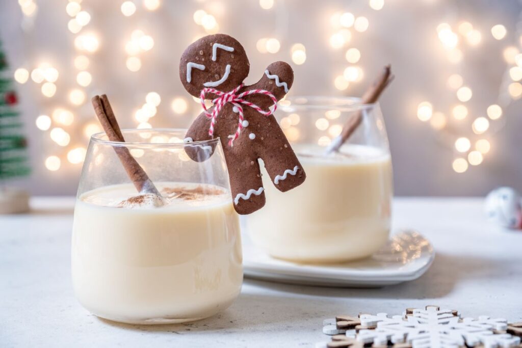 Two glasses of eggnog and a gingerbread man